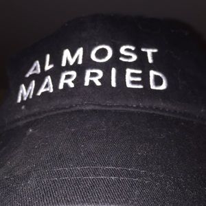 Black baseball hat, says “ALMOST MARRIED”
